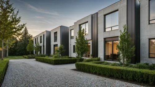 Modern German Row Houses with Concrete Facades and Tree-Lined Pathway